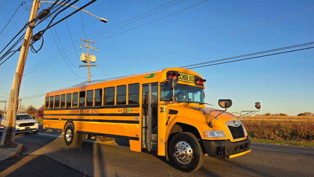 A yellow school bus driving on the road