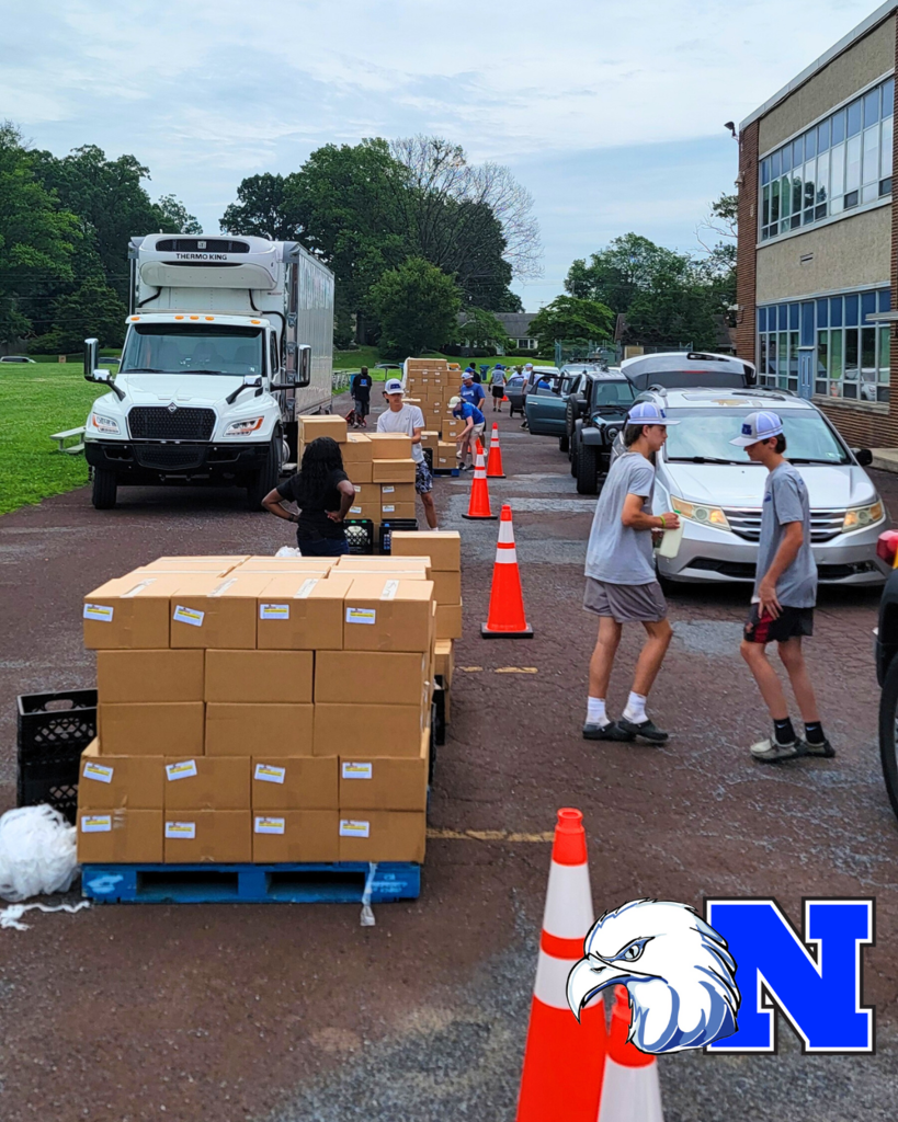 Student volunteers helping distribute meal boxes