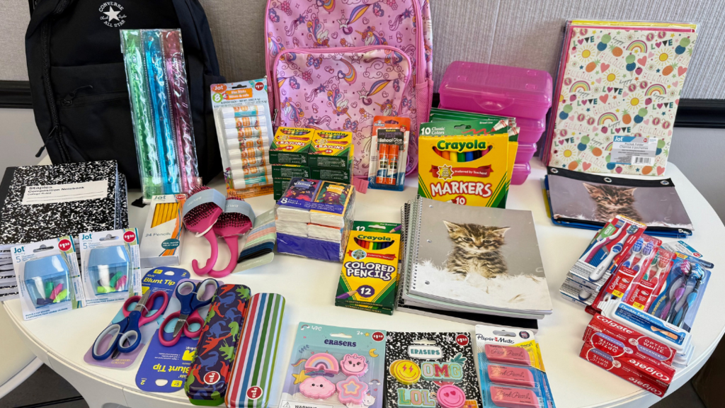Donated school supplies displayed on a table
