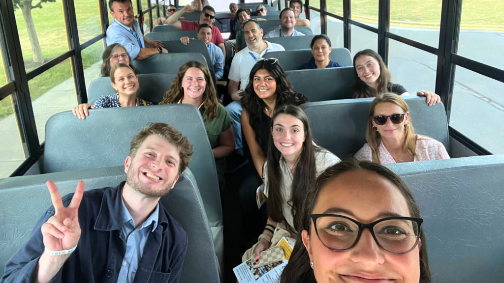 Bus Tour Guides take a selfie with new teachers on the bus.