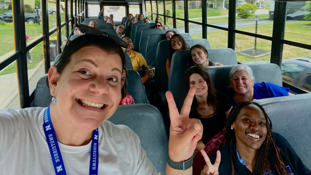 Bus Tour Guides take a selfie with new teachers on the bus.