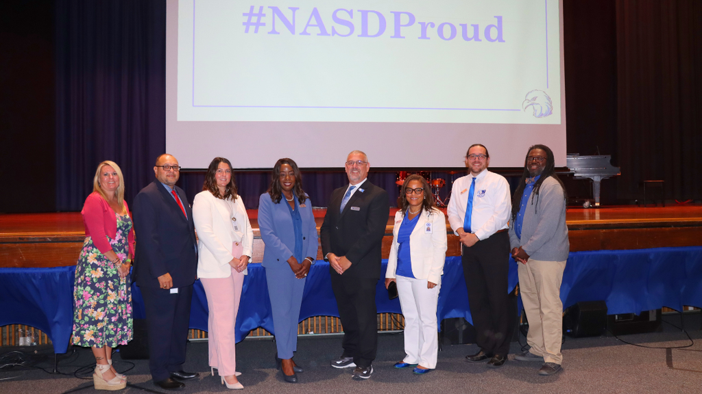 NASD Cabinet pose for group photo in front of the stage.