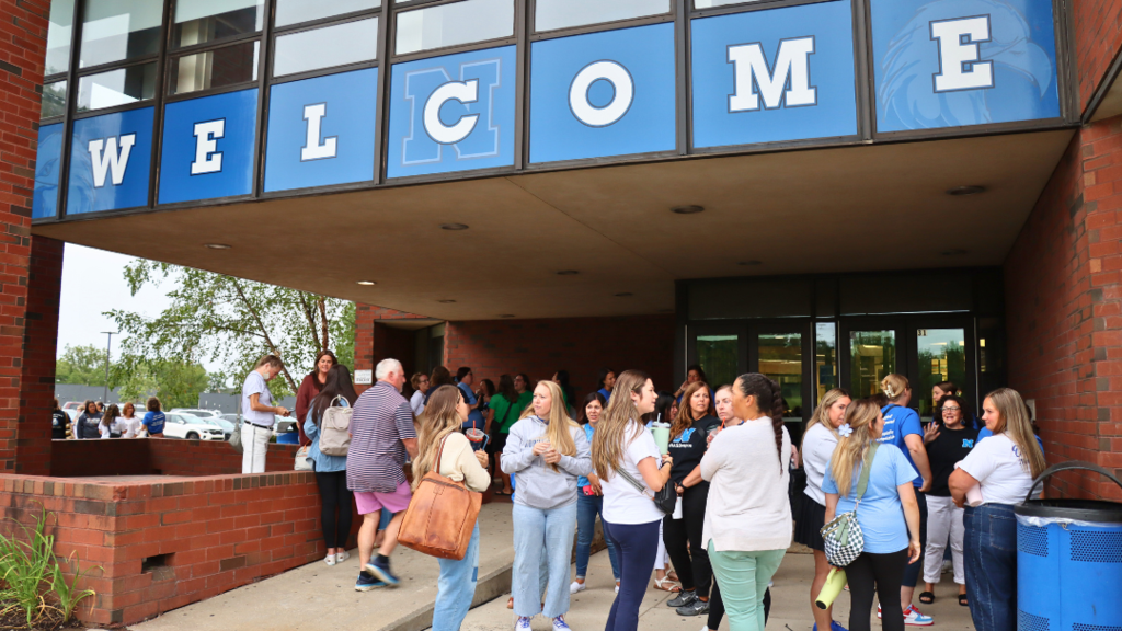 Teachers gathered outside of NAHS under the Welcome sign.