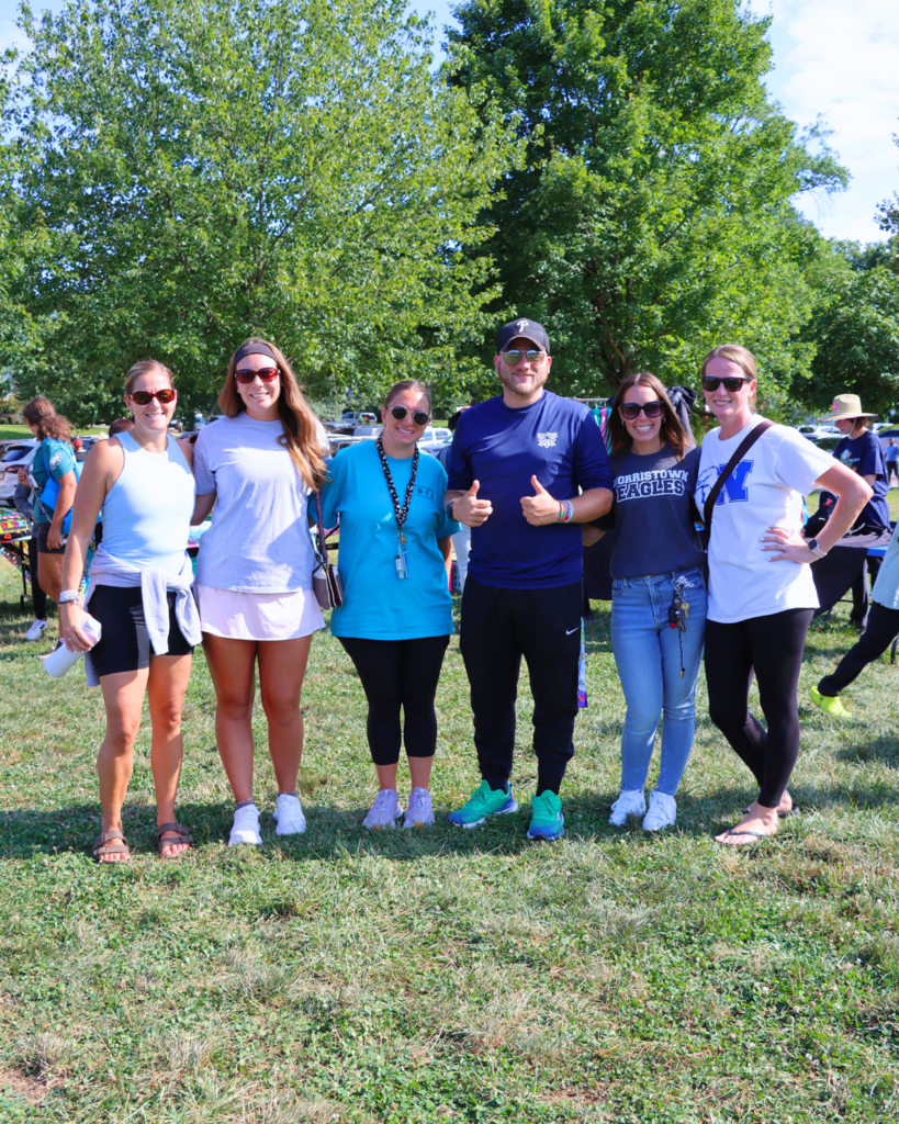 Group of staff members pose for a photo.