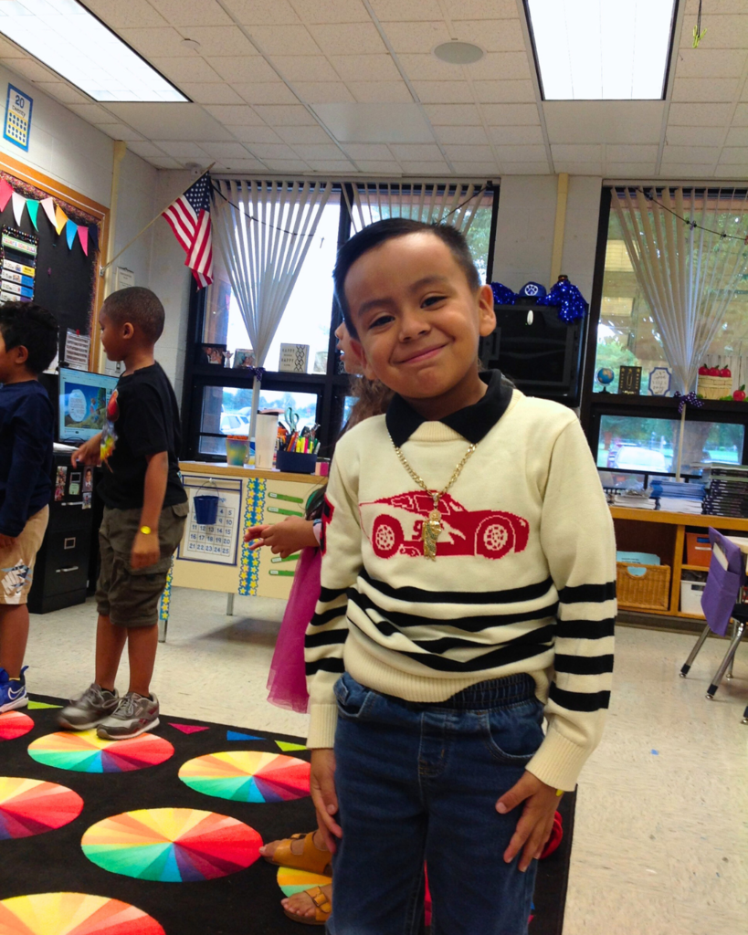 Young student poses for a photo in the classroom at a back to school event.