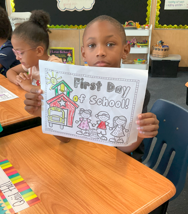 A student showing their first day of school coloring page. 