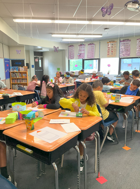 A group of students working on a back to school activity page. 