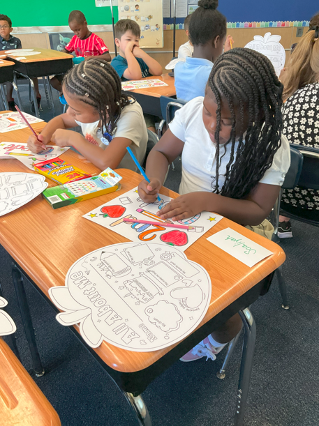 Two students working on a back to school activity. 