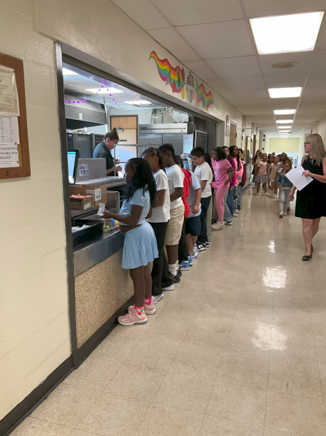 A group of students lining up for lunch. 