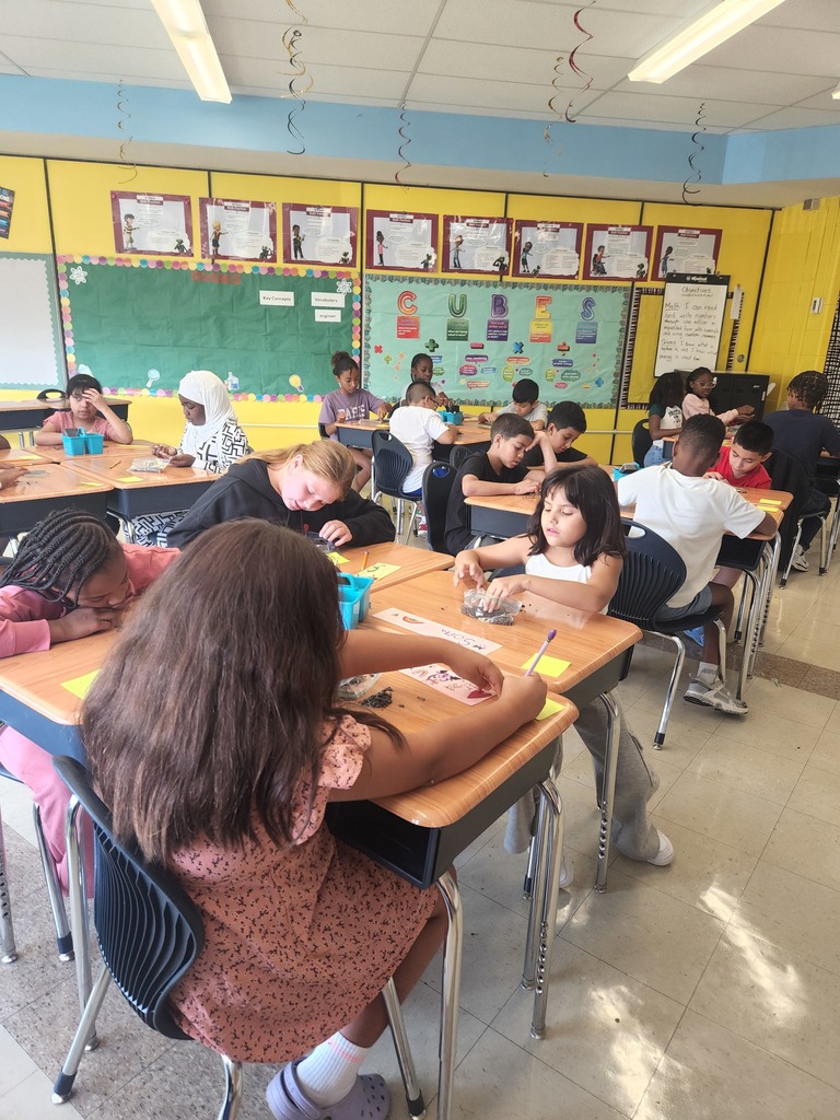 A group of students using watermelon seeds to work on place value. 
