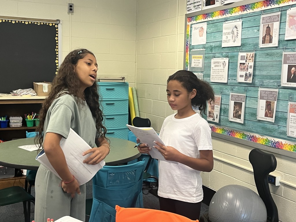 Students conversing with each other. More info in caption