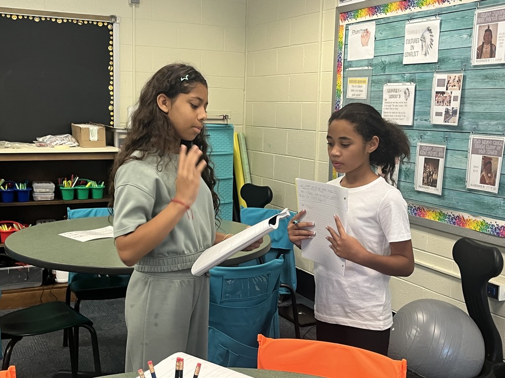 Students conversing with each other. More info in caption