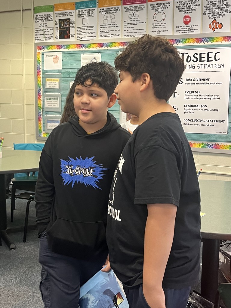Students conversing with each other. More info in caption