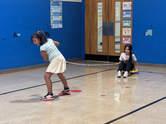 Two students working together in physical education class. 