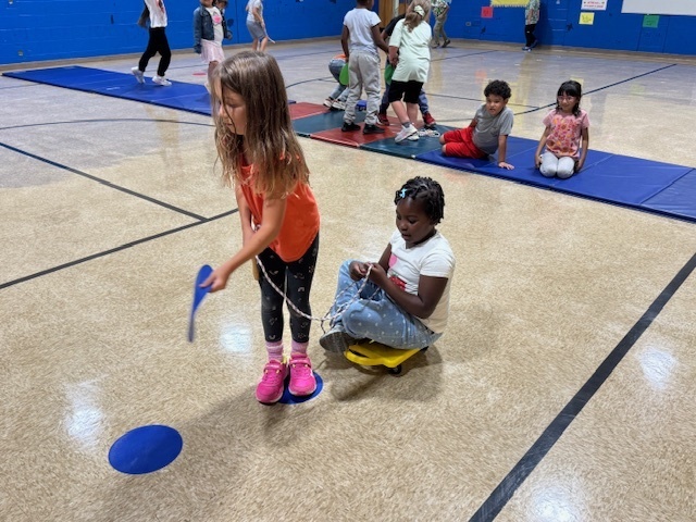 Two students working together in physical education class. 
