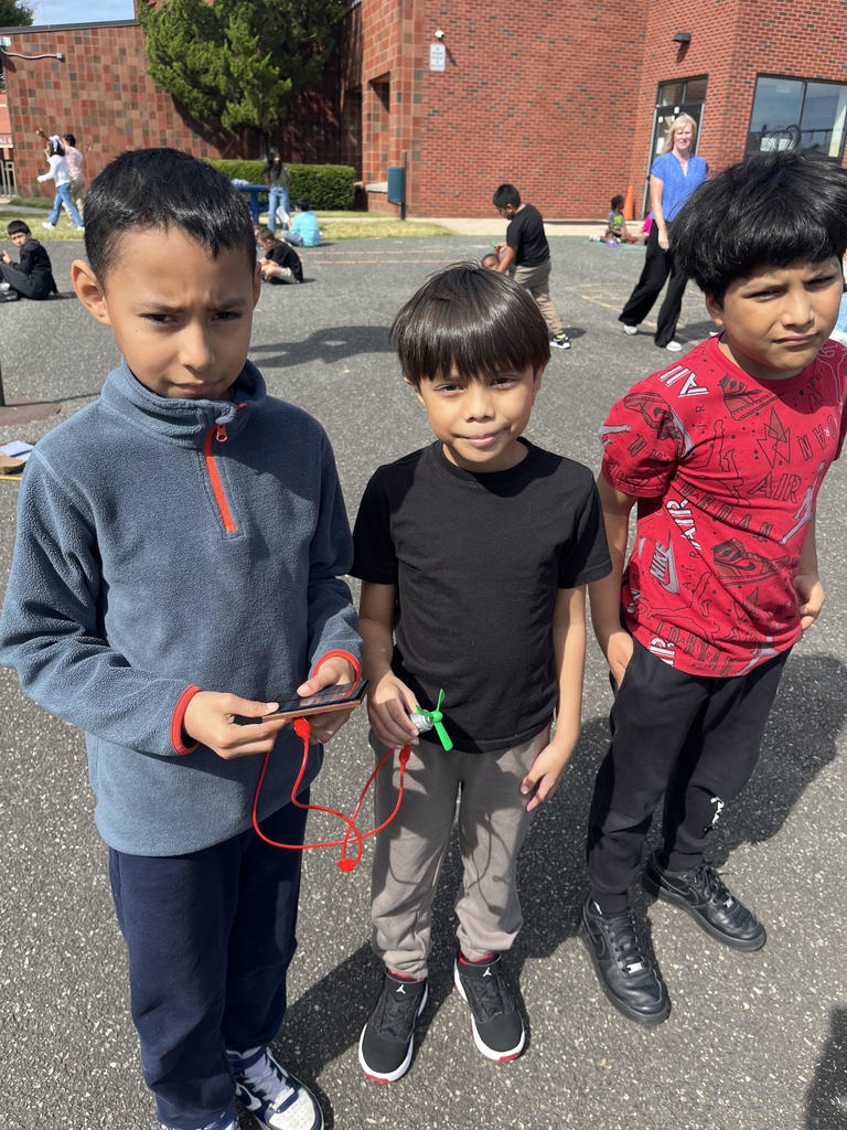 Three Fourth Graders showing their electrical circuit.