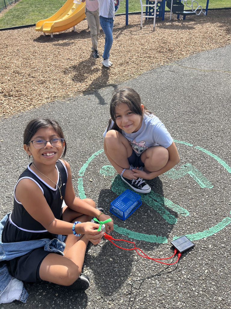 Two Fourth Graders showing their electrical circuit.
