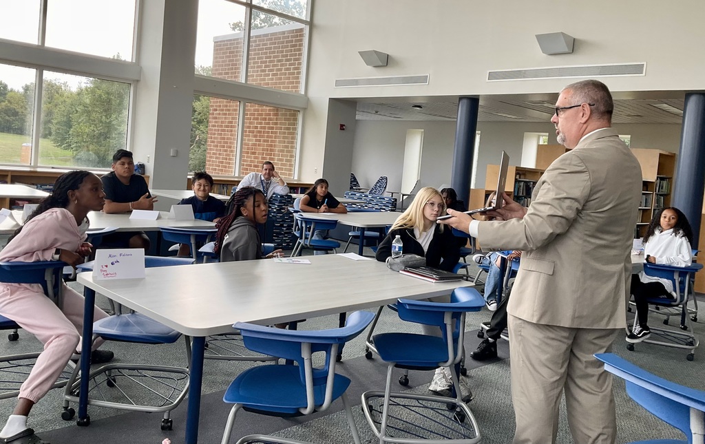 Students listening to district superintendent 