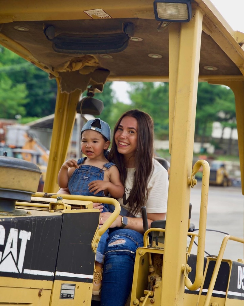 Teacher with son on construction truck