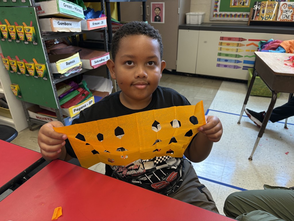 Student shows his papel picado project.