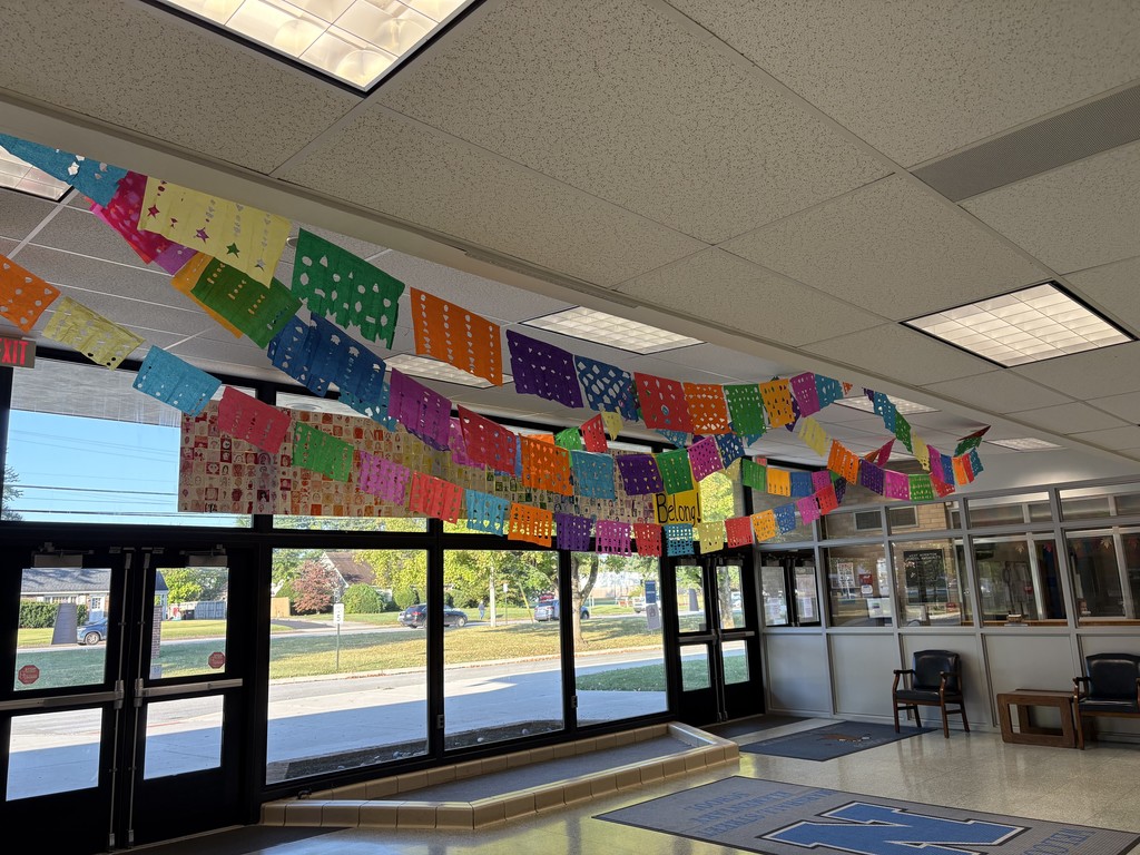 Papel picado projects on display in the lobby.