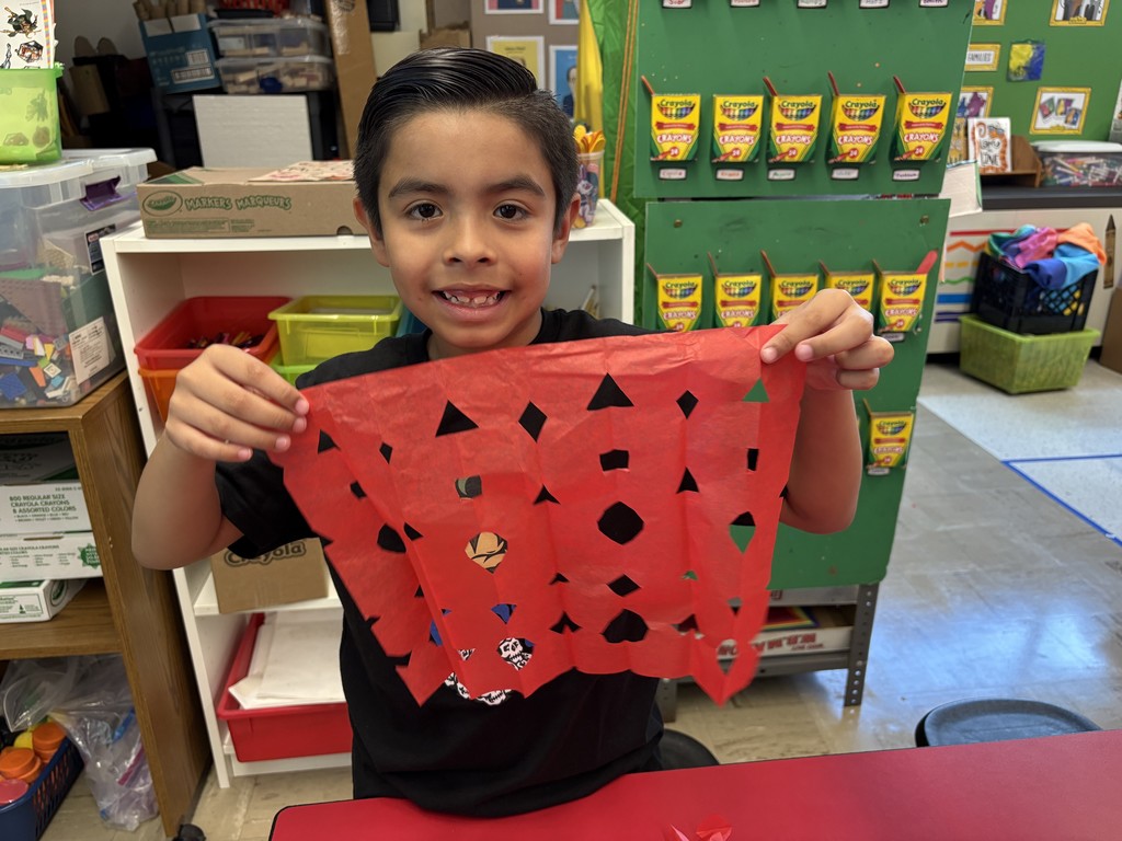 Student shows his papel picado project.
