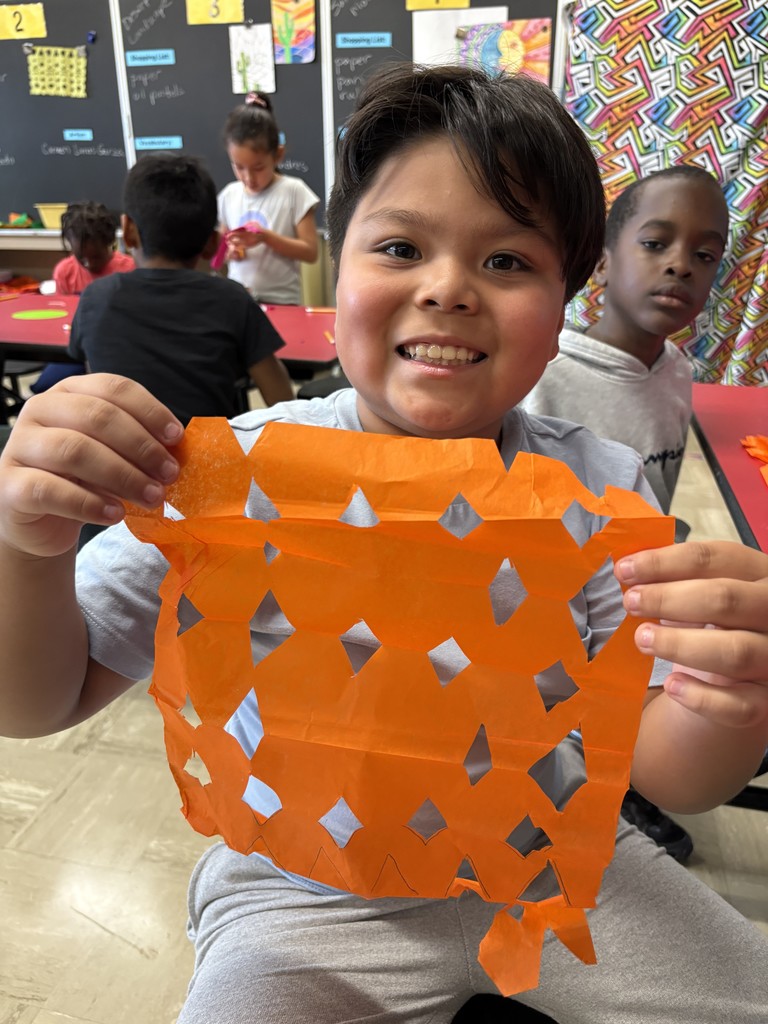 Student shows his papel picado project.