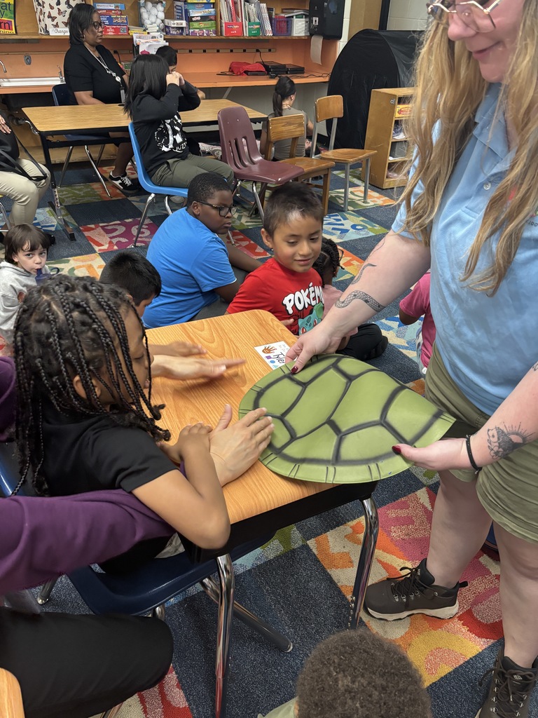 A student working with a member from the local zoo