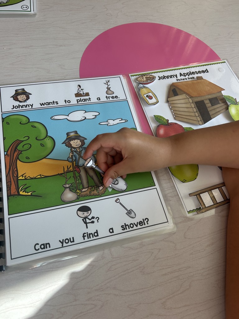 Photo of hand of a student finding Johnny Appleseed's shovel.