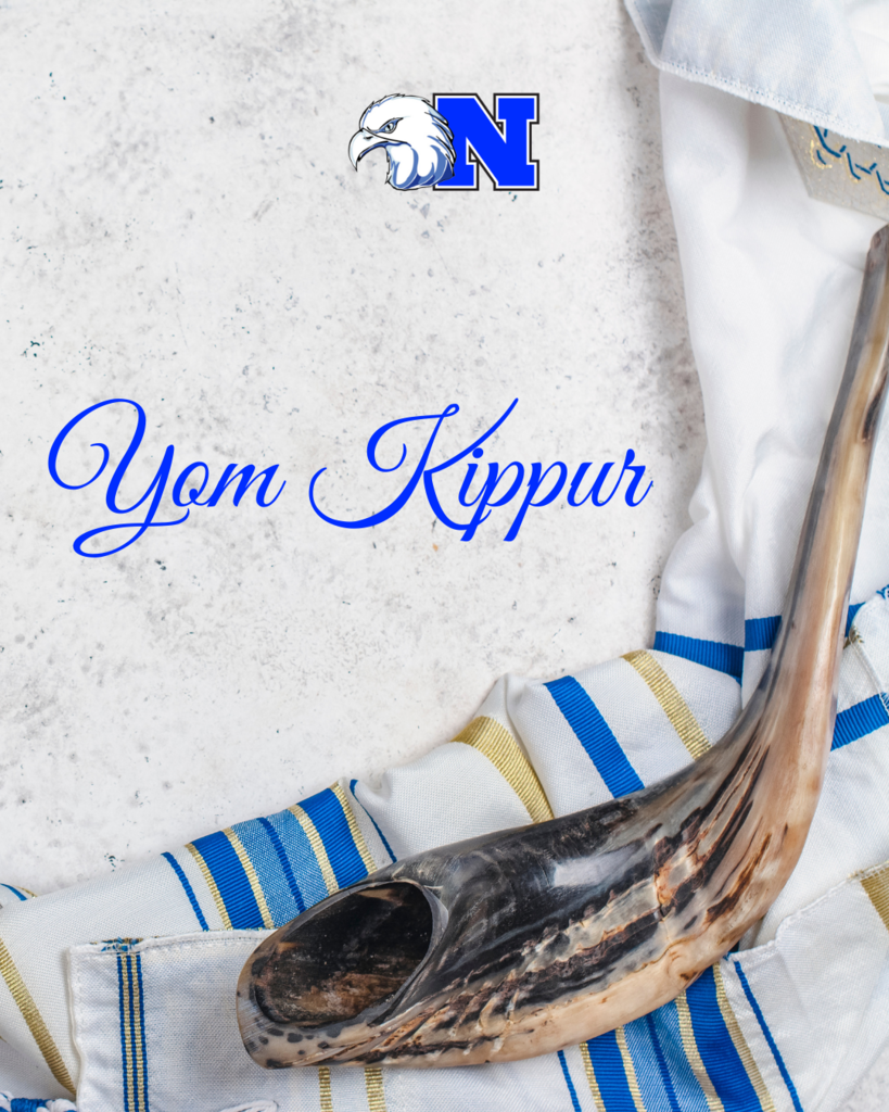 Shofar on a tallit with "Yom Kippur" written in blue script.