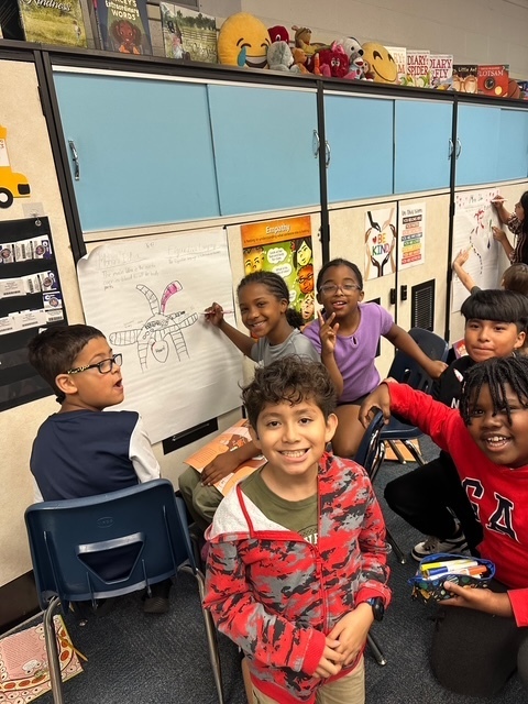 Students making a graffiti wall. 