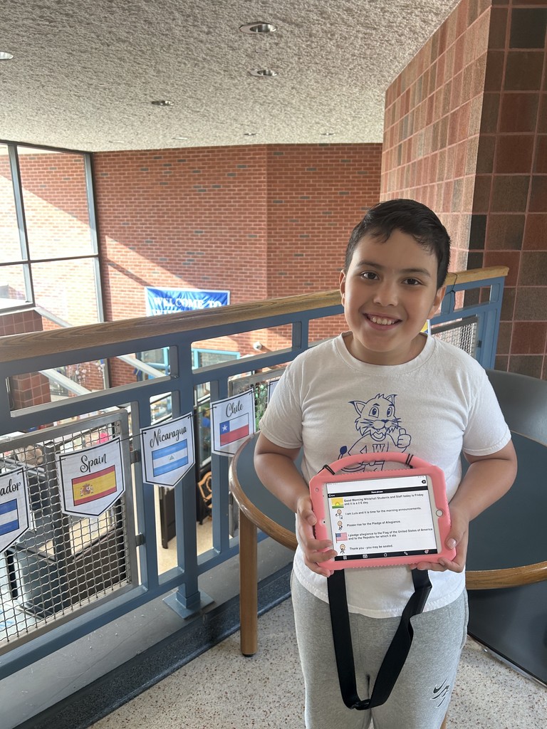 Photo of Luis and his Augmentative and Alternative Communication device.