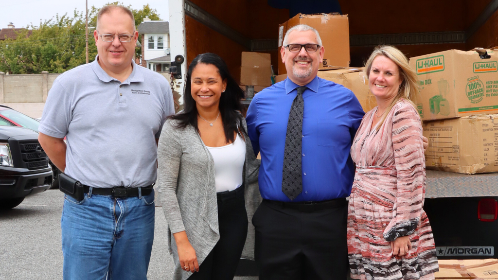 Montgomery County and NASD staff pose for photo before unloading the truck full of school supplies.