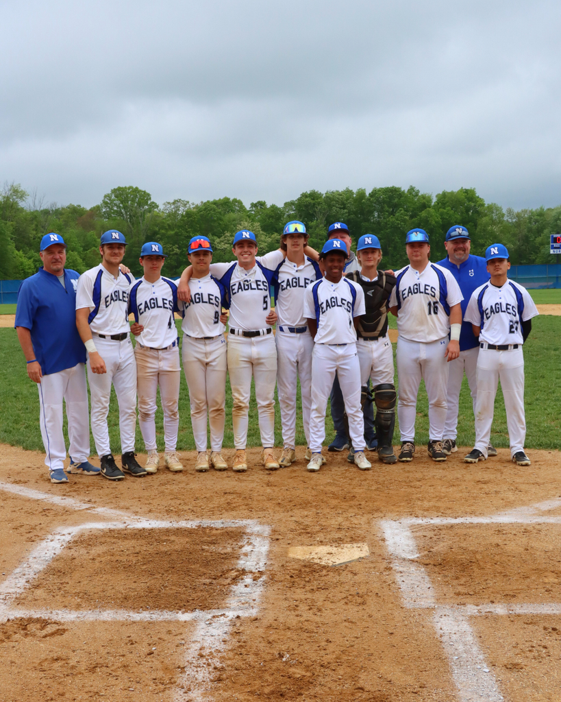 NAHS Baseball seniors and coaches pose for photo at home plate.