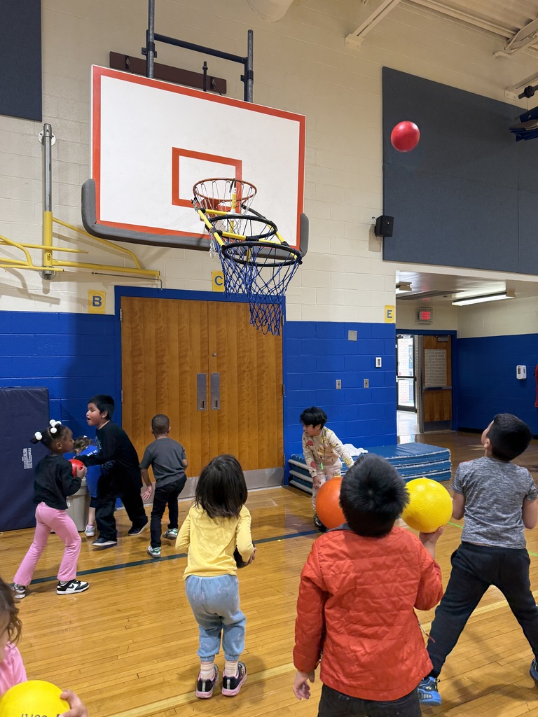 Kindergartners play games at stations during Physical Education class.