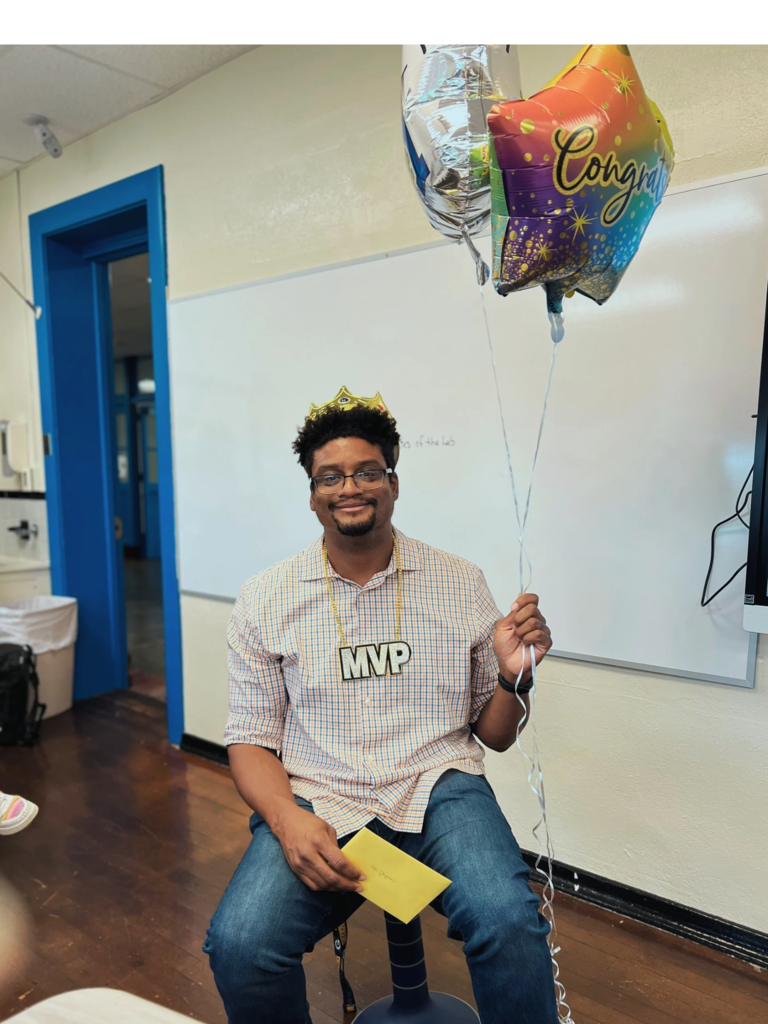 Mr. Jayroe poses with balloons and a crown because he was named the Roosevelt team member of the month