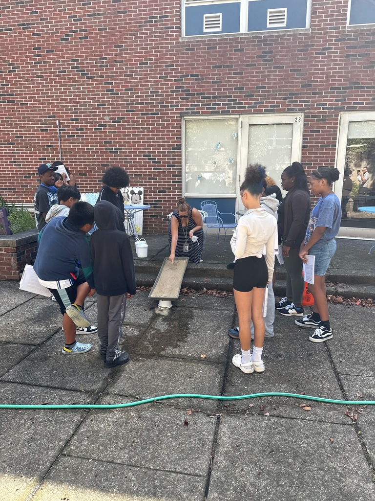Students studying stream table. More info in caption