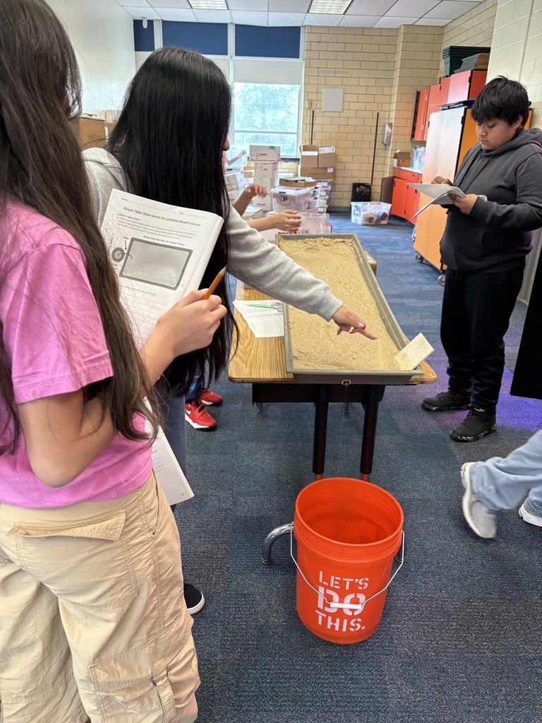 Students studying stream table. More info in caption