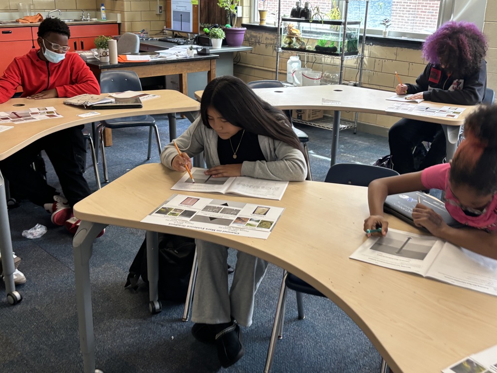 Students studying stream table. More info in caption
