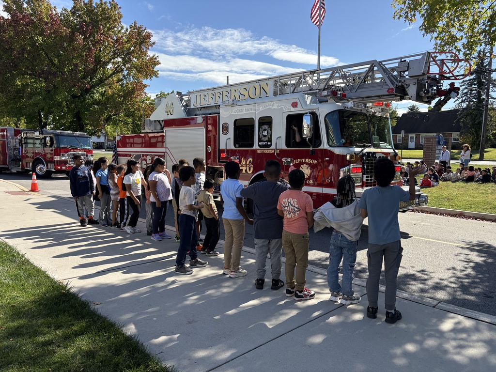 Students watch fire trucks as they leave the school.