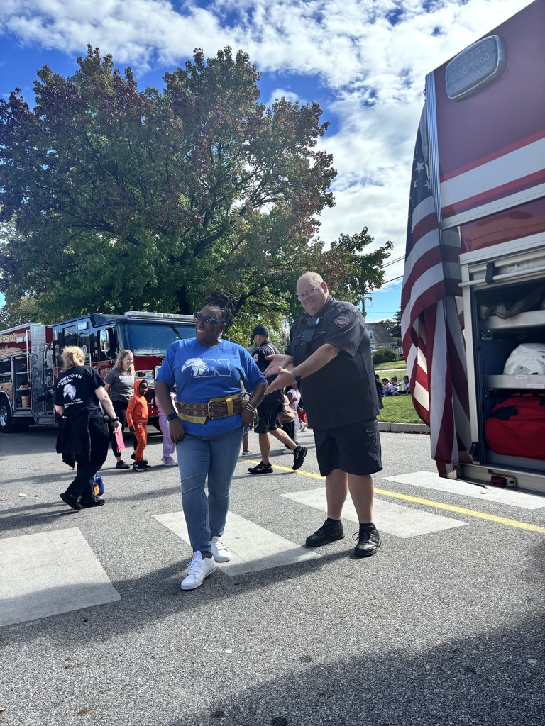 Principal Dr. Harper prepares to climb the ladder on the fire truck.