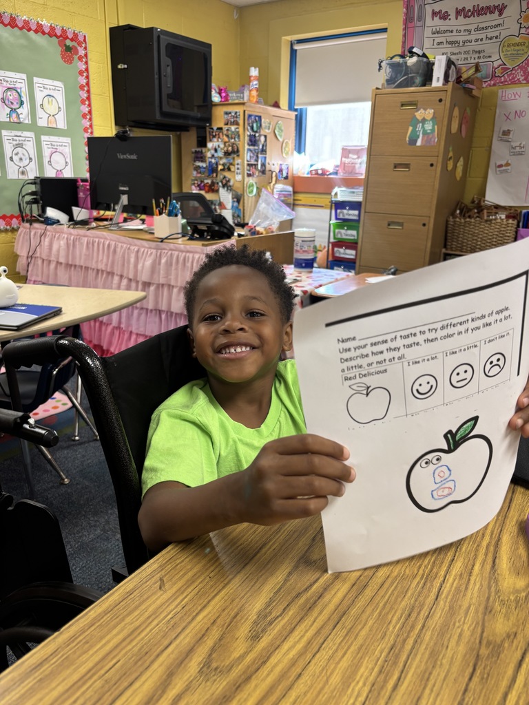 Students showing their apple artwork