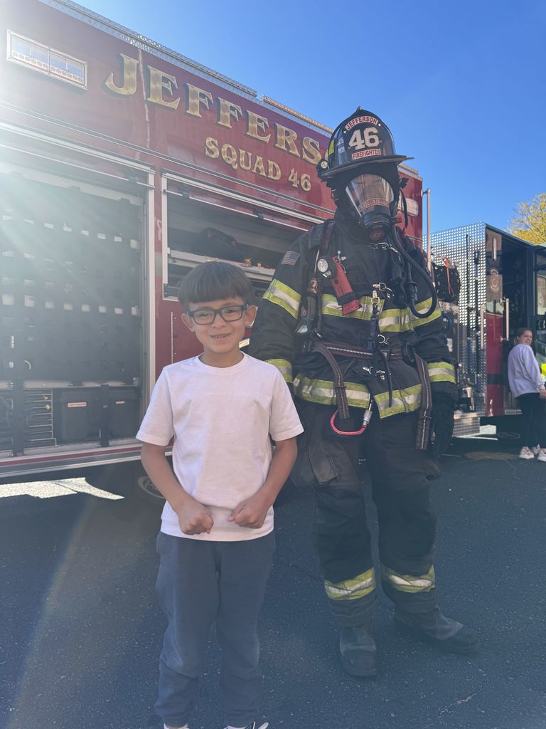 Photo of student with firefighter.