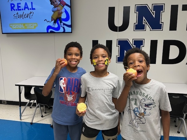 Three students eating apples!