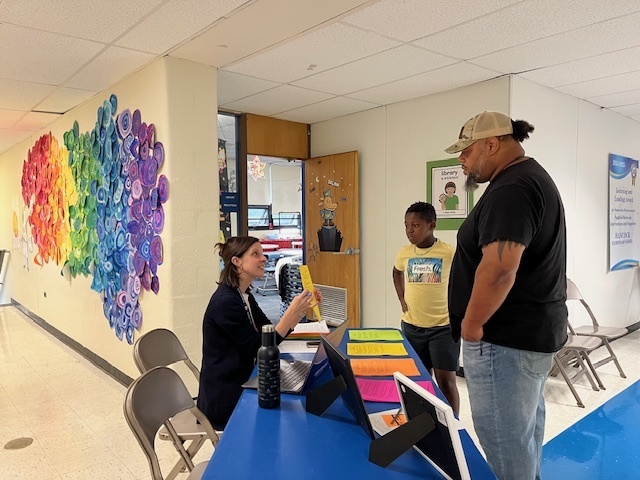 A teacher and a family having a conversation