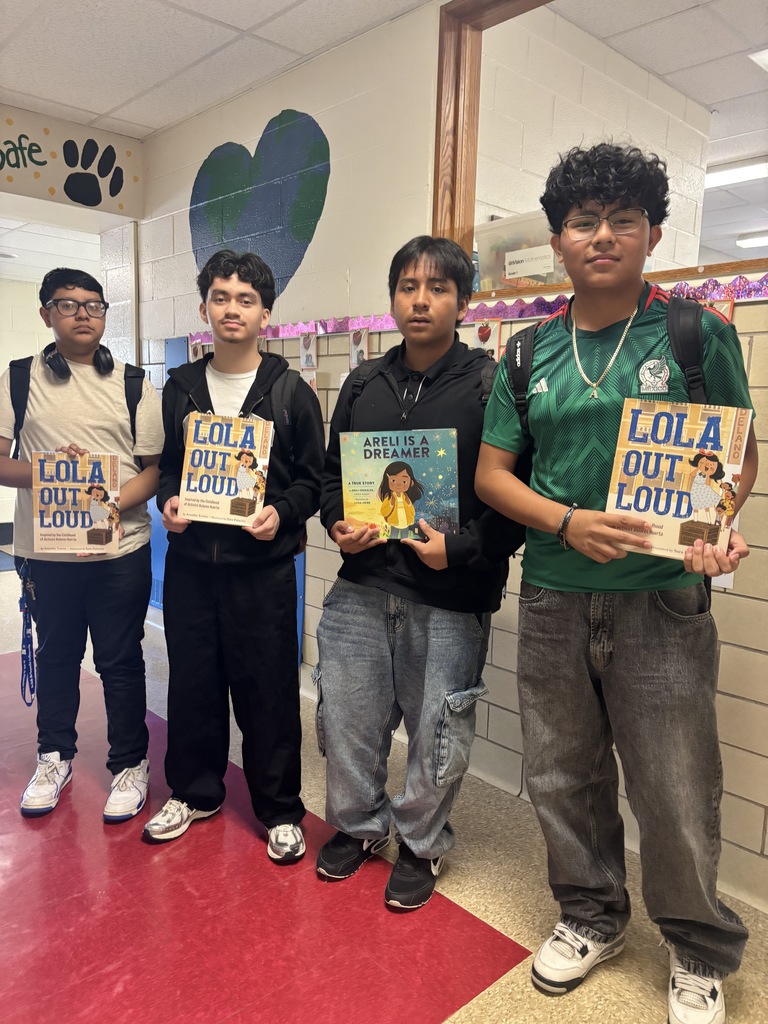 NAHS students share a book with students at Marshall Street Elementary School.