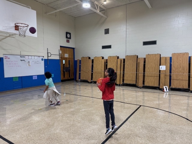 Students shooting baskets in physical education class
