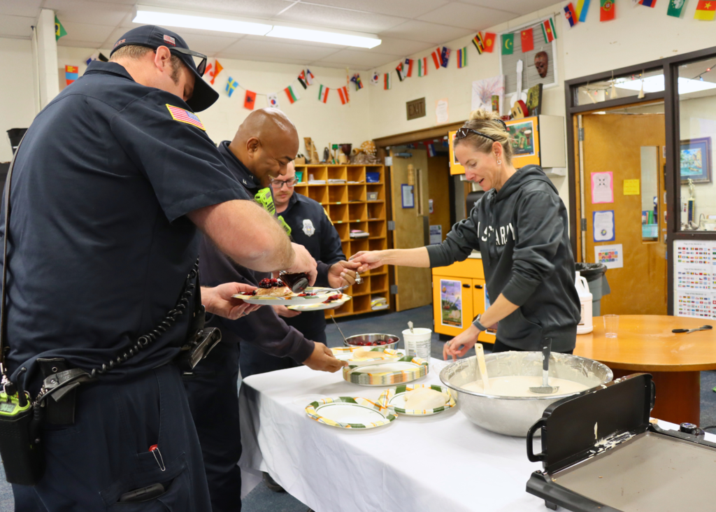 Teacher serves breakfast to first responders.