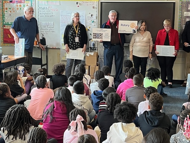 Rotary Club members presenting to third grade students. 