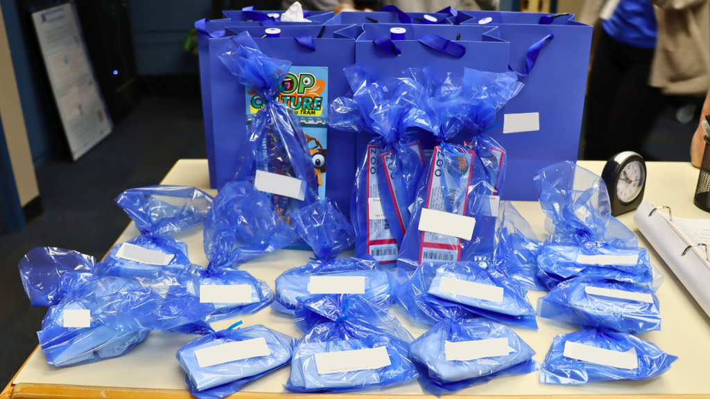 Prize gift bags displayed on counter ready for students to pick up.